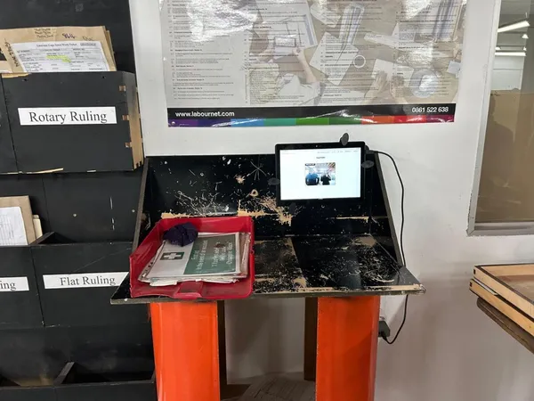 CrewPulse kiosk on a tablet at a factory desk workstation