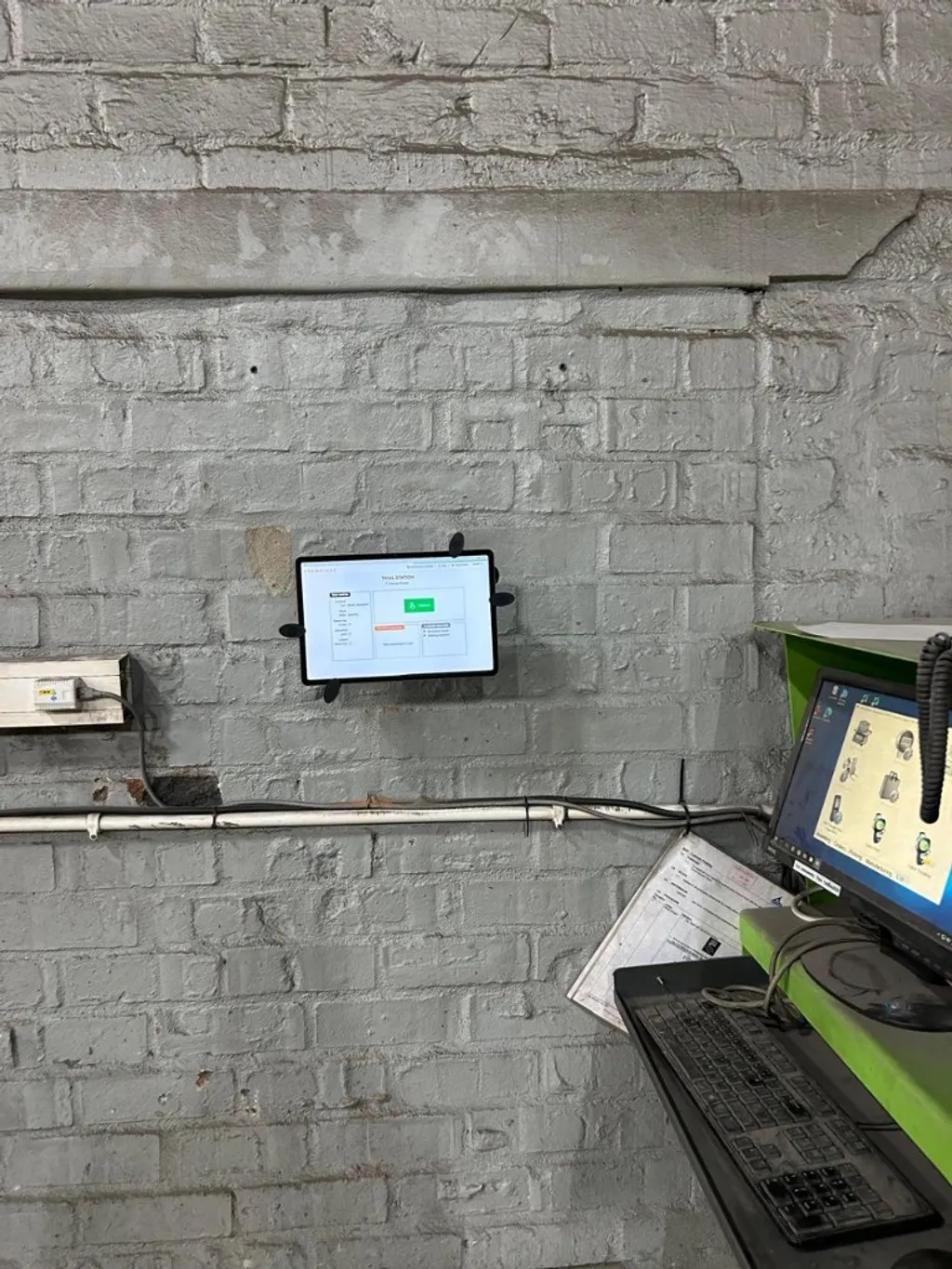 CrewPulse kiosk app on a wall-mounted tablet at a final station check-in point